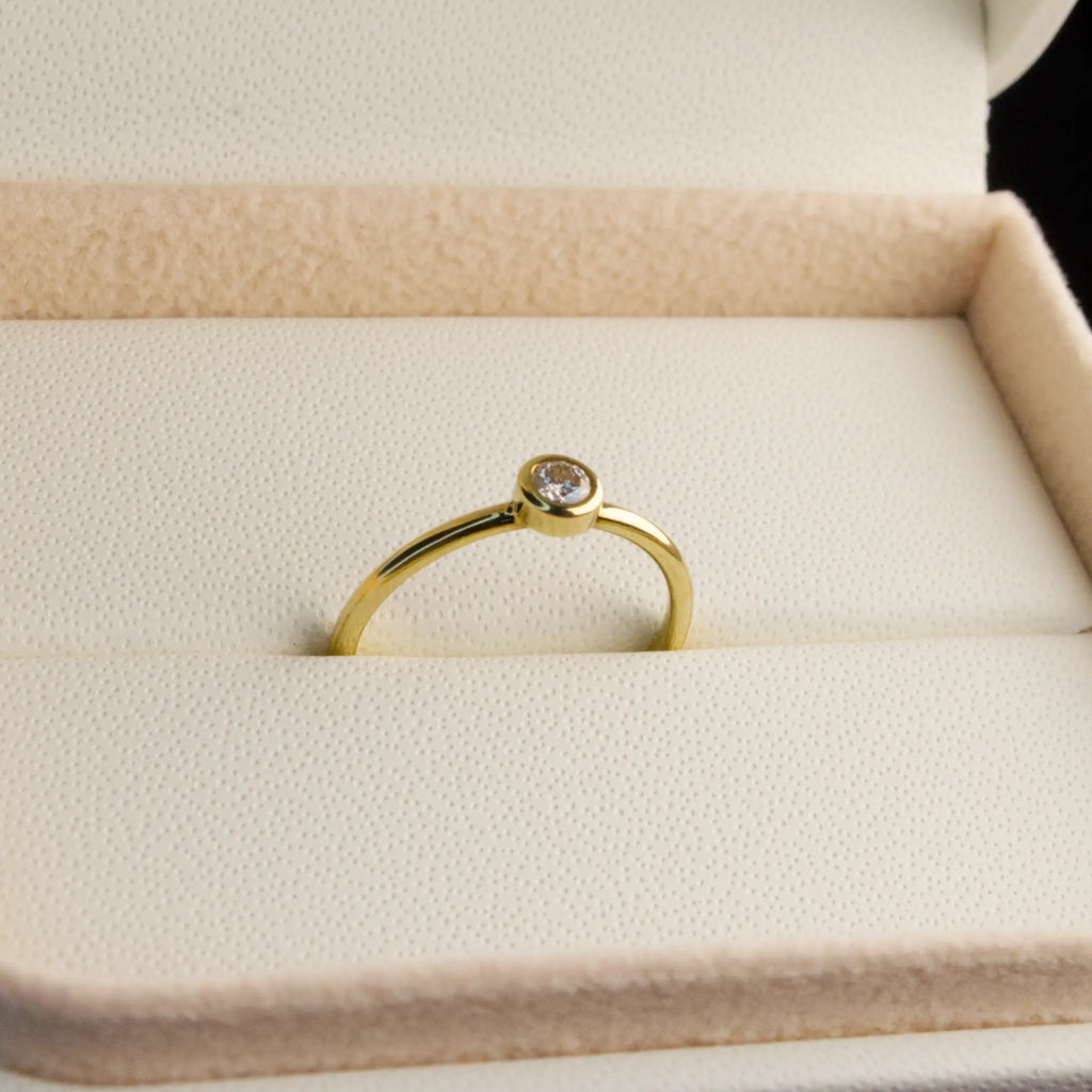 Dainty natural Diamond Bezel set ring in Yellow gold